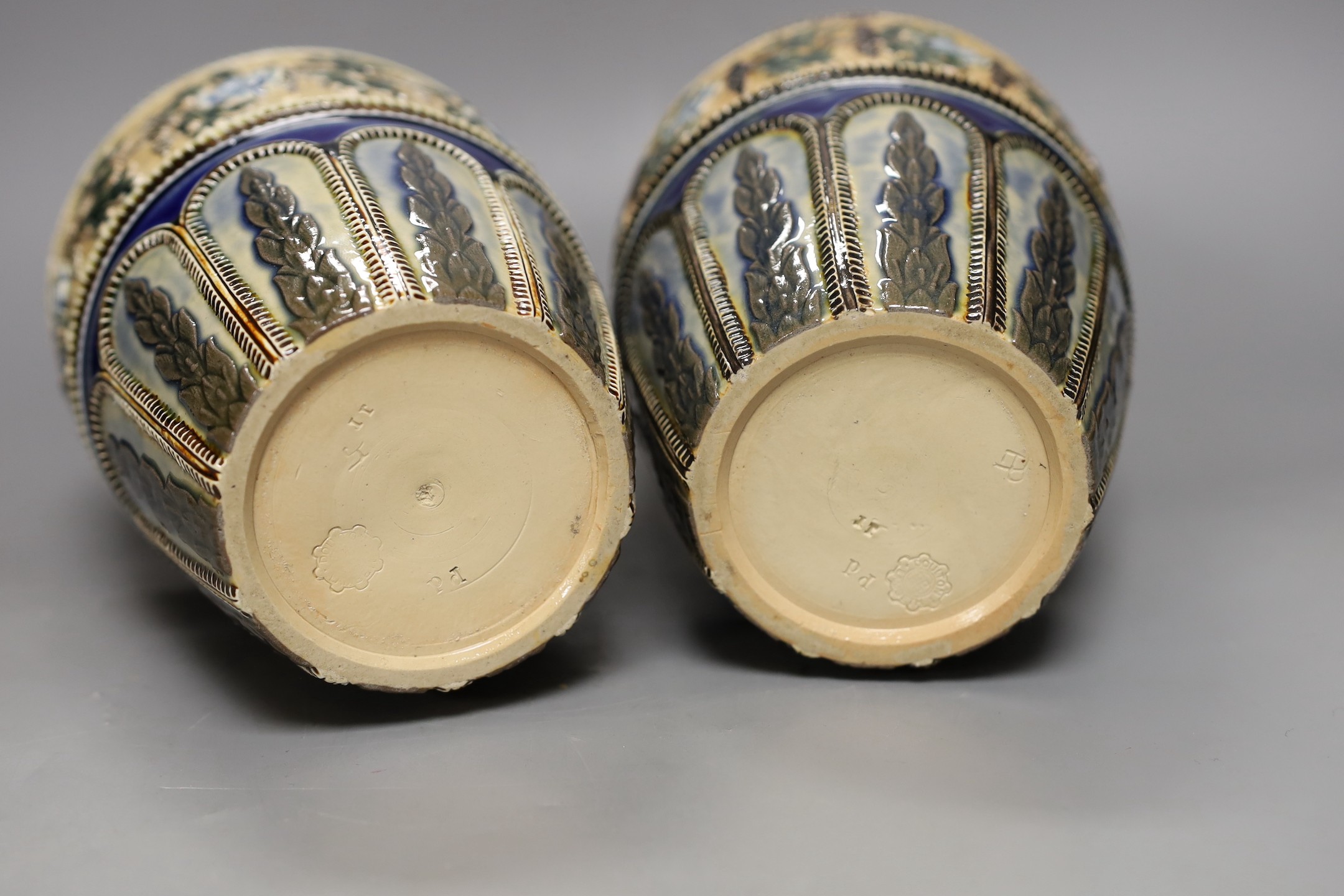 A pair of Doulton Lambeth vases, c.1885, 25.5cms high (a.f.)